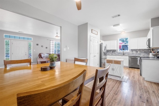 146 Long Shadow Dr, Bastrop, TX 78602 - dining room featuring ceiling fan, plenty of natural light, and light wood-style floors