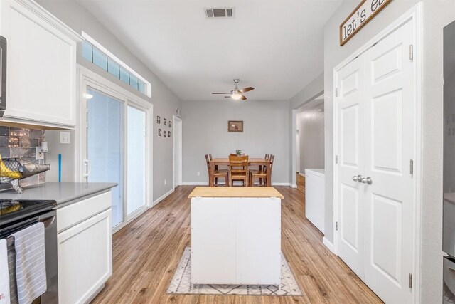 146 Long Shadow Dr, Bastrop, TX 78602 - kitchen featuring stainless steel electric stove, a ceiling fan, white cabinets, and light wood-style floors