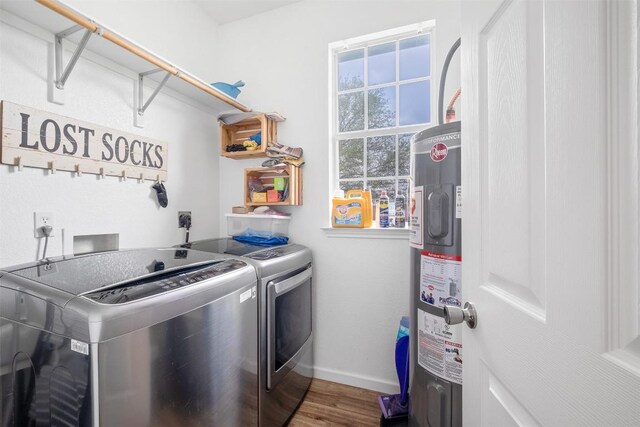 146 Long Shadow Dr, Bastrop, TX 78602 - washroom with washing machine and dryer, water heater, baseboards, and wood finished floors