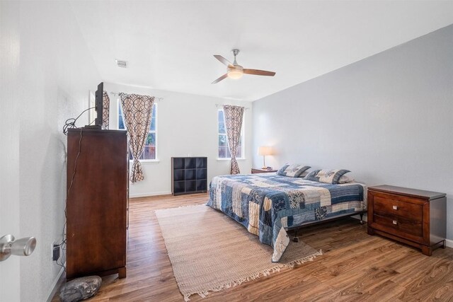 146 Long Shadow Dr, Bastrop, TX 78602 - bedroom with wood finished floors, baseboards, and a ceiling fan