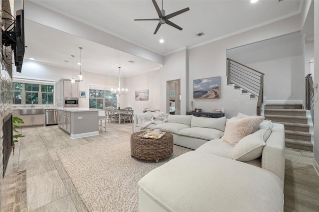 15004 Falconhead Grove Loop, Austin, TX 78738 - living room with stairway, ceiling fan, recessed lighting, ornamental molding, and a chandelier