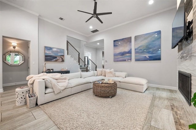 15004 Falconhead Grove Loop, Austin, TX 78738 - living room with ceiling fan, baseboards, stairs, a tile fireplace, and recessed lighting