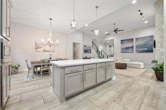 15004 Falconhead Grove Loop, Austin, TX 78738 - kitchen featuring gray cabinetry, ceiling fan, baseboards, a chandelier, and recessed lighting