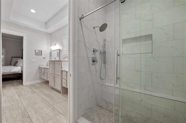 15004 Falconhead Grove Loop, Austin, TX 78738 - ensuite bathroom featuring a shower stall, vanity, baseboards, a tray ceiling, and recessed lighting