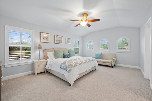 15004 Falconhead Grove Loop, Austin, TX 78738 - bedroom featuring multiple windows, vaulted ceiling, baseboards, light carpet, and ceiling fan