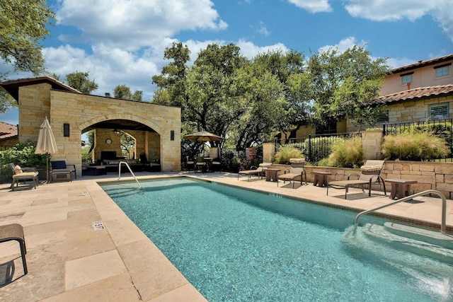 15004 Falconhead Grove Loop, Austin, TX 78738 - community pool featuring a patio, fence, and exterior fireplace