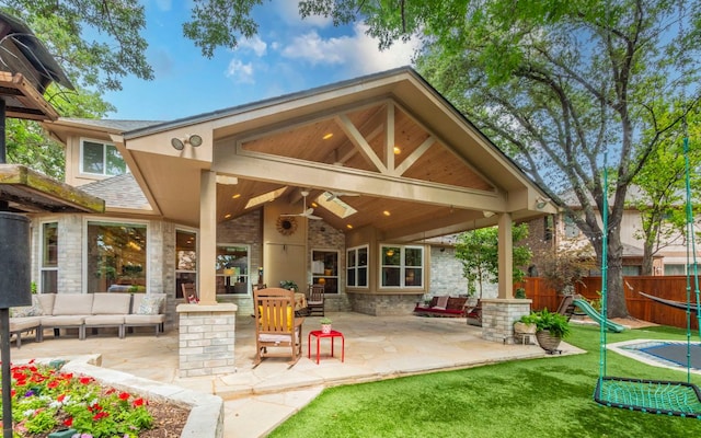 back of property with an outdoor hangout area, a patio, and ceiling fan