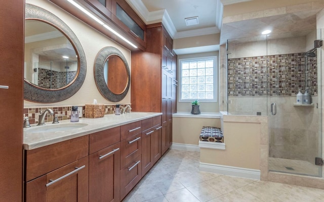 bathroom featuring crown molding, a shower stall, tile patterned floors, double vanity, and decorative backsplash