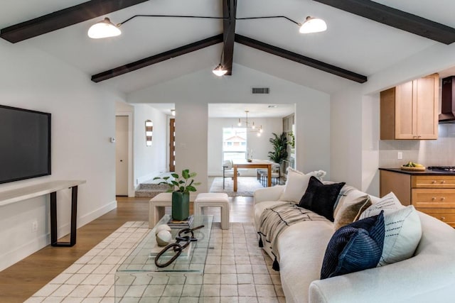 5711 Wellington Dr, Austin, TX 78723 - living area with light wood finished floors and a chandelier