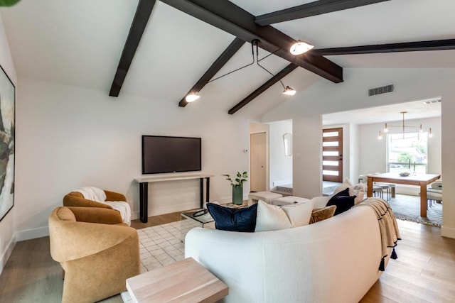 5711 Wellington Dr, Austin, TX 78723 - living area with light wood-type flooring and a chandelier
