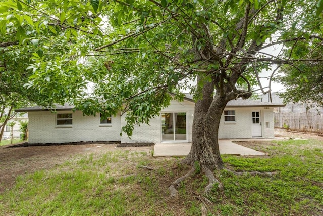 5711 Wellington Dr, Austin, TX 78723 - rear view of property with brick siding and a patio