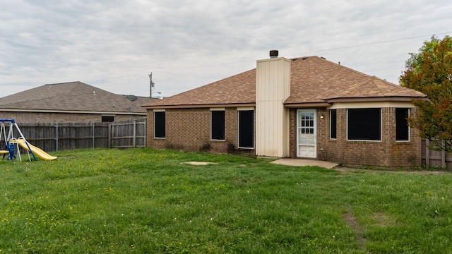 2605 Little Nolan Rd, Killeen, TX 76542 - rear view of house featuring a chimney, brick siding, roof with shingles, and a playground