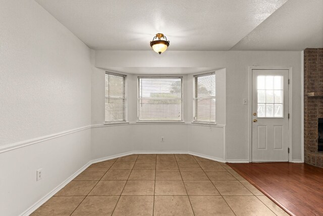 2605 Little Nolan Rd, Killeen, TX 76542 - foyer entrance with a fireplace, light tile patterned floors, and baseboards