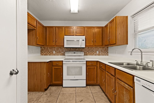 2605 Little Nolan Rd, Killeen, TX 76542 - kitchen with white appliances, a sink, brown cabinetry, and light countertops