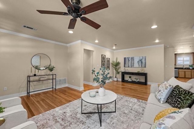 3214 Funston St, Austin, TX 78703 - living room featuring light wood-type flooring, a ceiling fan, recessed lighting, and ornamental molding