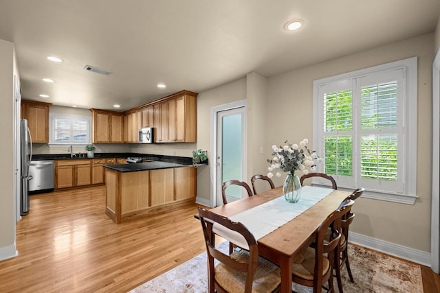 3214 Funston St, Austin, TX 78703 - dining room featuring light wood finished floors and recessed lighting