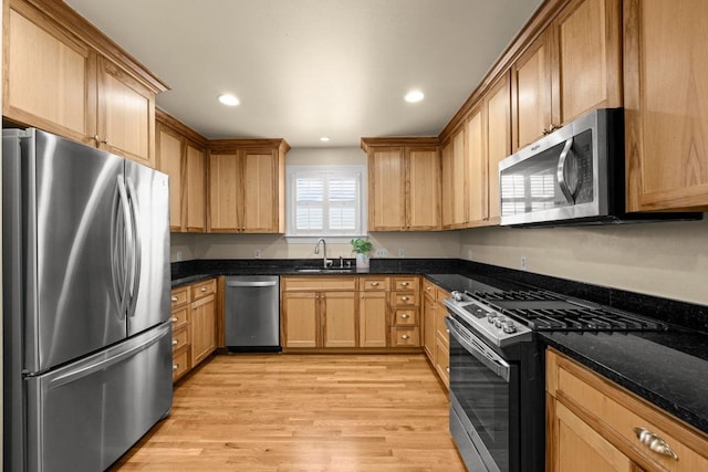 3214 Funston St, Austin, TX 78703 - kitchen featuring stainless steel appliances, light wood-style flooring, recessed lighting, and dark stone countertops