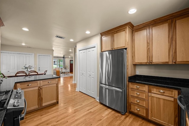 3214 Funston St, Austin, TX 78703 - kitchen with freestanding refrigerator, light wood-style floors, recessed lighting, brown cabinetry, and dishwasher