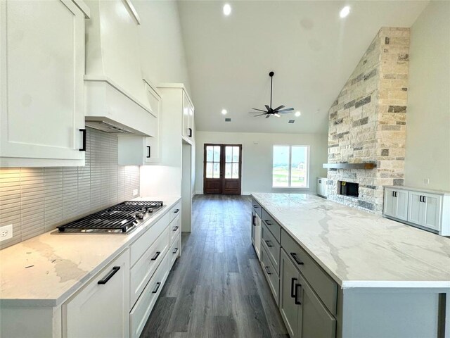 5501 Hollow Loop, Salado, TX 76571 - kitchen with stainless steel gas cooktop, a ceiling fan, high vaulted ceiling, tasteful backsplash, and open floor plan