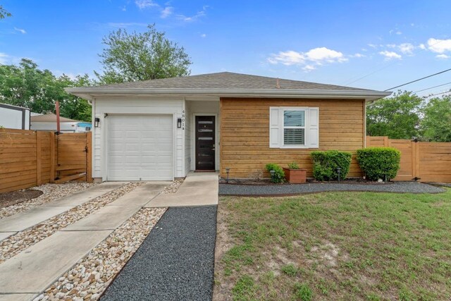 4801 Louis Ave Unit 1, Austin, TX 78721 - view of front facade featuring concrete driveway, a garage, and a gate