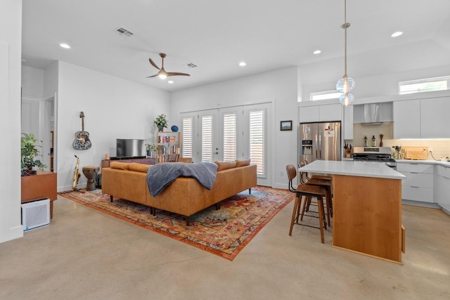 4801 Louis Ave Unit 1, Austin, TX 78721 - living room with recessed lighting, ceiling fan, and finished concrete floors