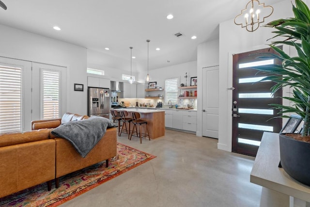 4801 Louis Ave Unit 1, Austin, TX 78721 - living area with finished concrete flooring, recessed lighting, and a chandelier