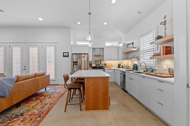 4801 Louis Ave Unit 1, Austin, TX 78721 - kitchen with modern cabinets, appliances with stainless steel finishes, open shelves, a kitchen bar, and a sink