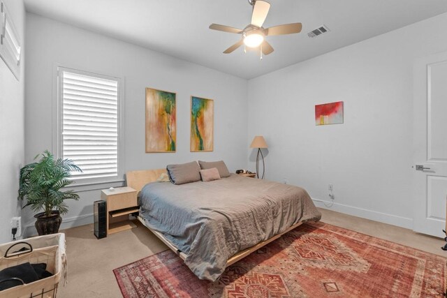 4801 Louis Ave Unit 1, Austin, TX 78721 - bedroom with light colored carpet, baseboards, and a ceiling fan