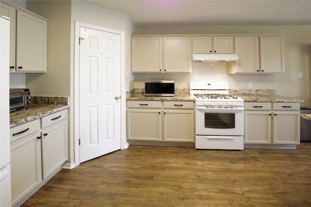 kitchen featuring white gas range, under cabinet range hood, stainless steel microwave, dark wood-type flooring, and light stone counters