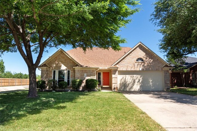 2418 Madeline Loop, Cedar Park, TX 78613 - ranch-style home featuring a garage, concrete driveway, roof with shingles, and stone siding