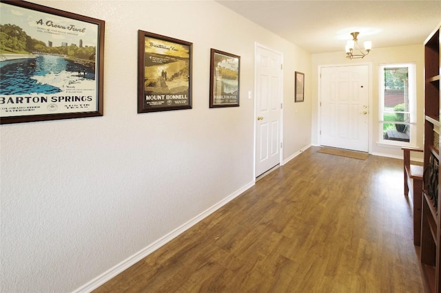 2418 Madeline Loop, Cedar Park, TX 78613 - foyer entrance with wood finished floors, a chandelier, and baseboards