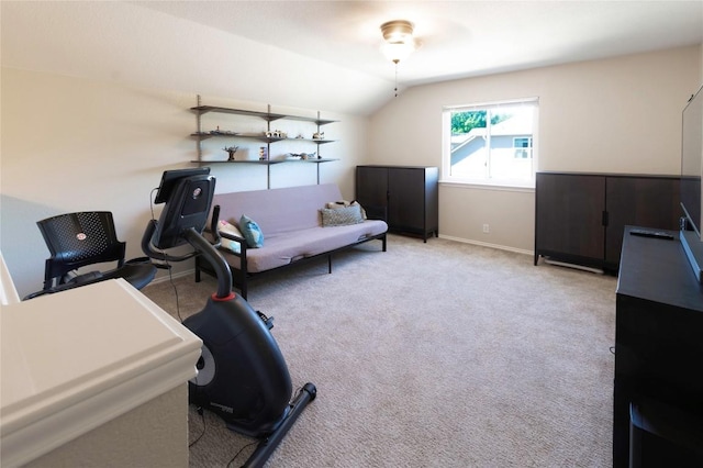workout area featuring lofted ceiling, carpet floors, and baseboards