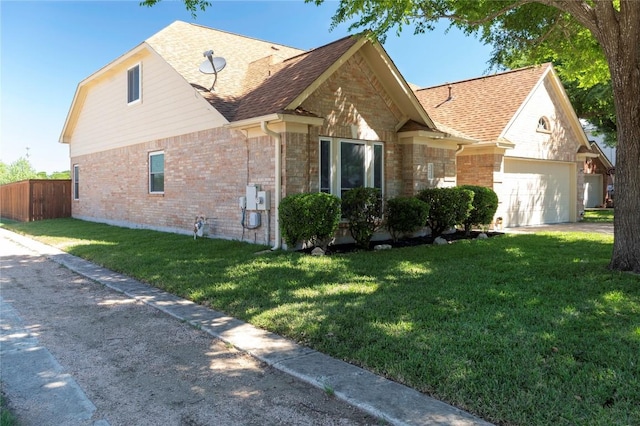 view of front of home featuring roof with shingles, brick siding, a garage, and driveway