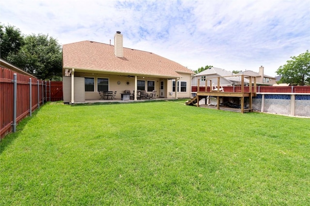 back of property featuring a chimney and a patio area