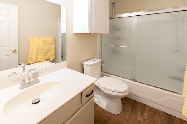 2418 Madeline Loop, Cedar Park, TX 78613 - bathroom with wood finished floors, toilet, vanity, and shower / bath combination with glass door