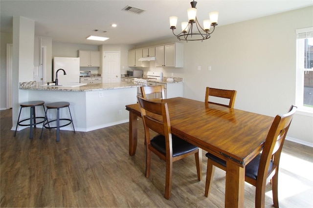 2418 Madeline Loop, Cedar Park, TX 78613 - dining area featuring dark wood-style floors, a chandelier, baseboards, and recessed lighting