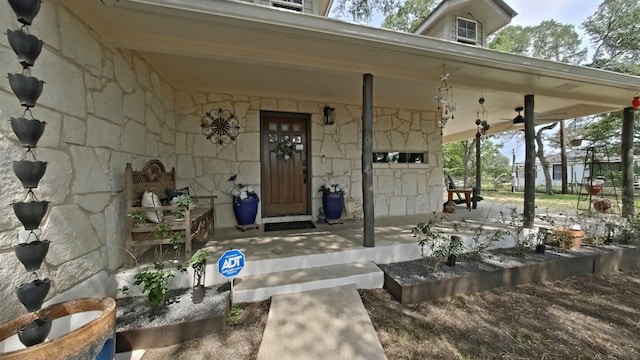 1127 Penion Dr, Austin, TX 78748 - doorway to property featuring stone siding and a porch
