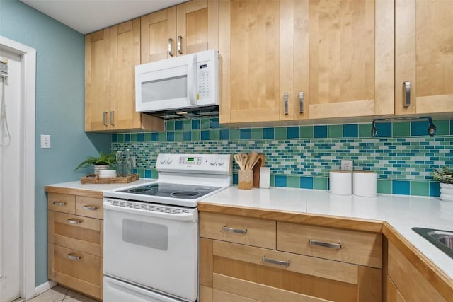 2104 Cullen Ave Unit 223, Austin, TX 78757 - kitchen with white appliances, backsplash, light countertops, and light brown cabinetry