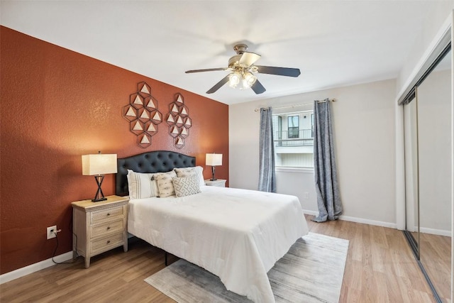 2104 Cullen Ave Unit 223, Austin, TX 78757 - bedroom with light wood finished floors, a closet, a ceiling fan, and baseboards
