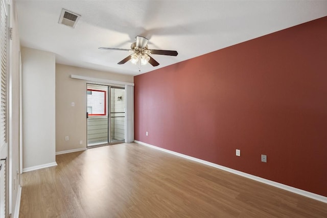 2104 Cullen Ave Unit 223, Austin, TX 78757 - empty room with a ceiling fan, wood finished floors, and baseboards