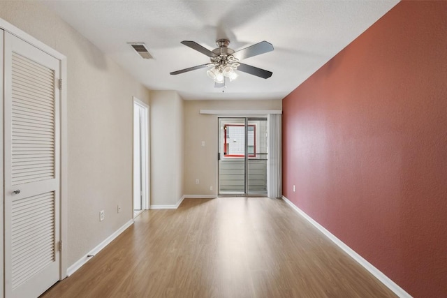 2104 Cullen Ave Unit 223, Austin, TX 78757 - unfurnished room with light wood-style floors, a ceiling fan, and baseboards
