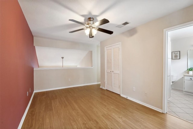 2104 Cullen Ave Unit 223, Austin, TX 78757 - unfurnished bedroom with wood finished floors, a closet, baseboards, and a ceiling fan