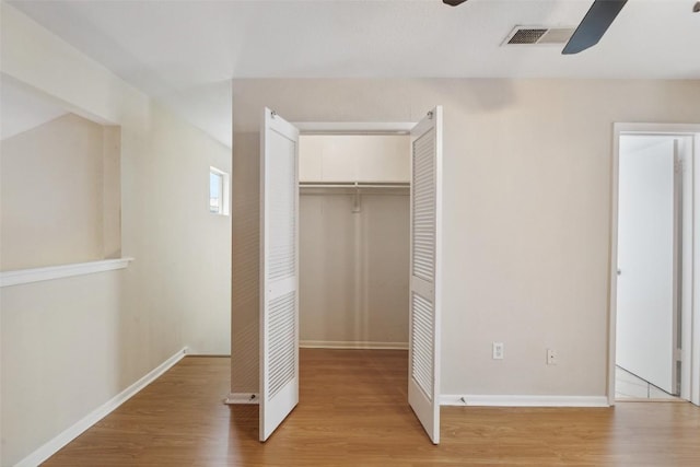2104 Cullen Ave Unit 223, Austin, TX 78757 - unfurnished bedroom with light wood-style flooring, a closet, baseboards, and ceiling fan