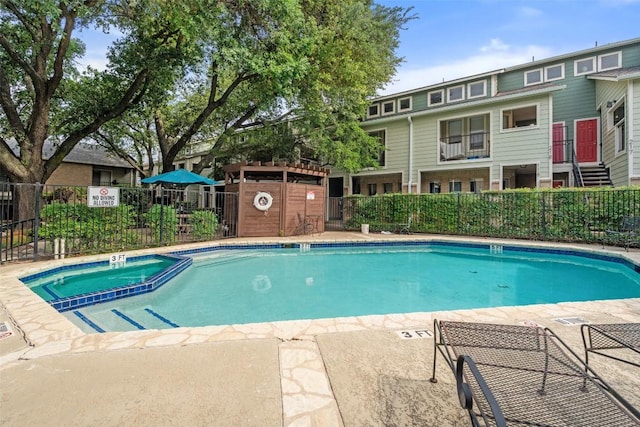 2104 Cullen Ave Unit 223, Austin, TX 78757 - view of swimming pool featuring fence and a pool with connected hot tub