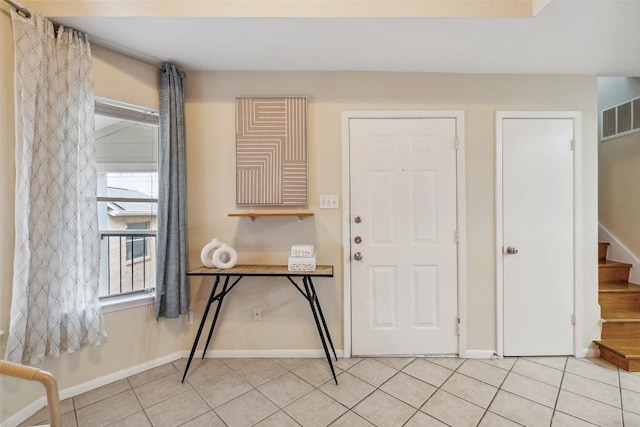 2104 Cullen Ave Unit 223, Austin, TX 78757 - foyer featuring stairway, baseboards, and light tile patterned floors