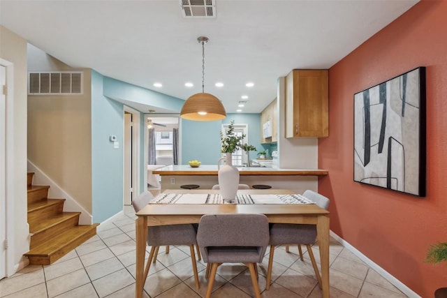 2104 Cullen Ave Unit 223, Austin, TX 78757 - dining area featuring light tile patterned flooring, stairs, and recessed lighting