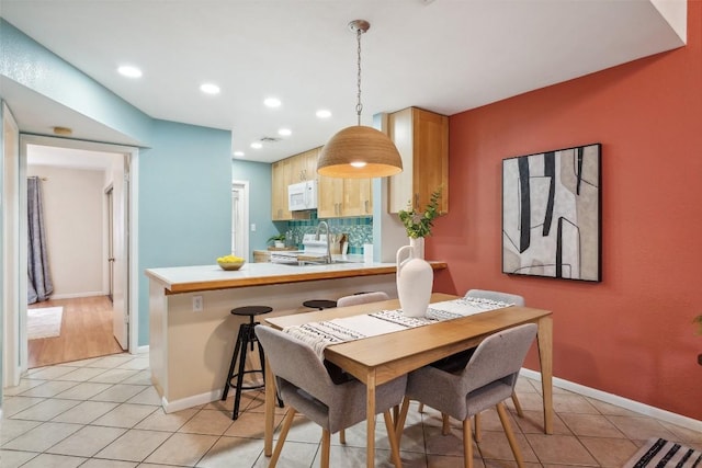 2104 Cullen Ave Unit 223, Austin, TX 78757 - dining room with light tile patterned floors, recessed lighting, and baseboards