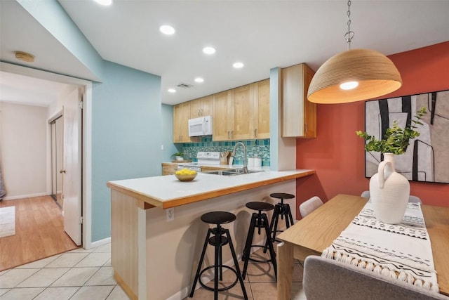 2104 Cullen Ave Unit 223, Austin, TX 78757 - kitchen featuring white appliances, a sink, recessed lighting, decorative backsplash, and light countertops