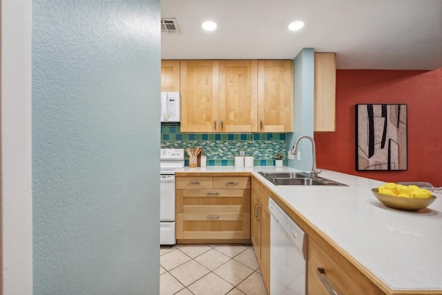 2104 Cullen Ave Unit 223, Austin, TX 78757 - kitchen featuring white appliances, a sink, a textured wall, decorative backsplash, and light countertops