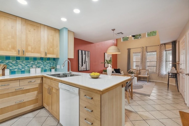 2104 Cullen Ave Unit 223, Austin, TX 78757 - kitchen with white dishwasher, a sink, light brown cabinets, and recessed lighting
